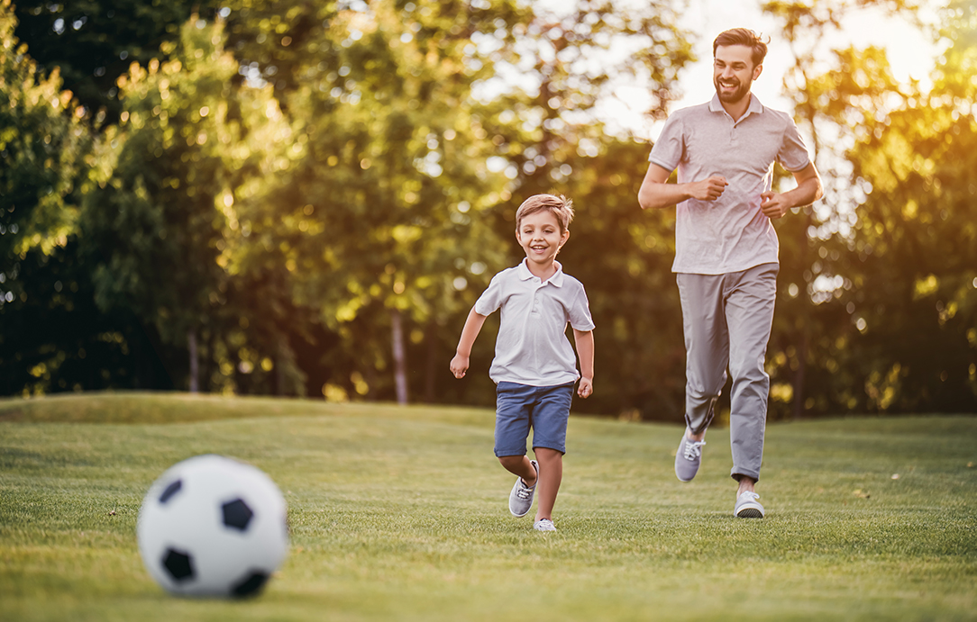 Man & Boy Playing Football